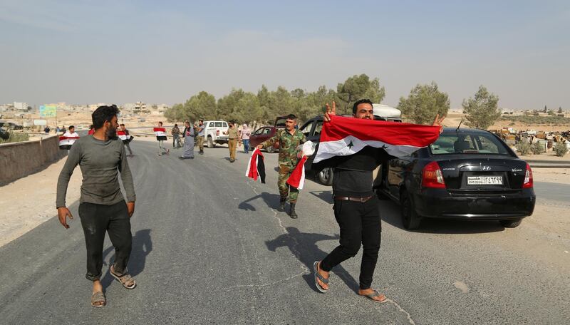 Syrian locals, carrying Syrian flags, cheer for the Syrian army in the city of Manbej and its surroundings in Aleppo provinces northeastern countryside, Syria. According to media reports, the soldiers were welcomed by the locals, who have gathered in the city center, carrying Syrian flags and cheering for the army which came to encounter the Turkish aggression.  EPA