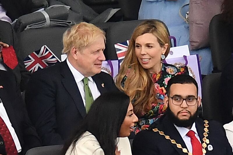 UK Prime Minister Boris Johnson and his wife Carrie Johnson take their seats. AFP