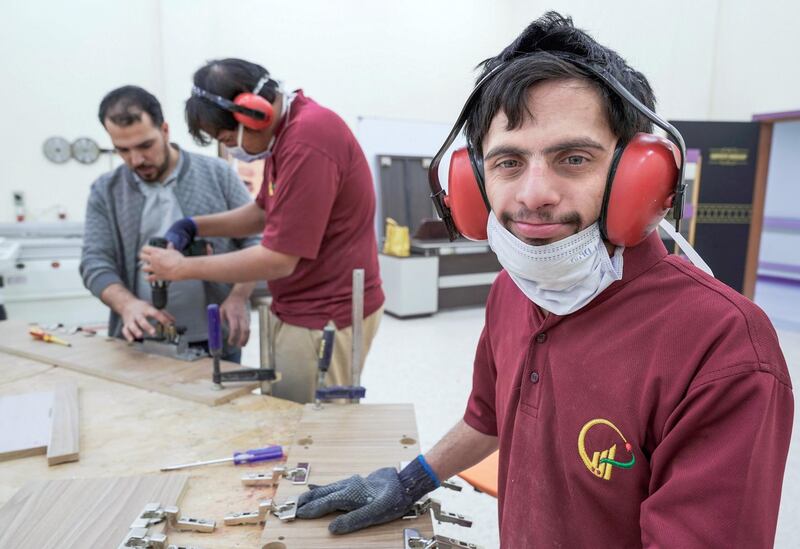 Abu Dhabi, United Arab Emirates, February 13, 2020.  
   Story Brief:  A story on the carpentry workshop at Zayed High Organisation for people of determination, where people with special needs aremaking tables and podiums that are used in government buildings and mosques. 

--Omar Al Marzooqi installing hinges on a wooden plank.
     
Victor Besa / The National
Section:  NA
Reporter:  Haneen Dajani