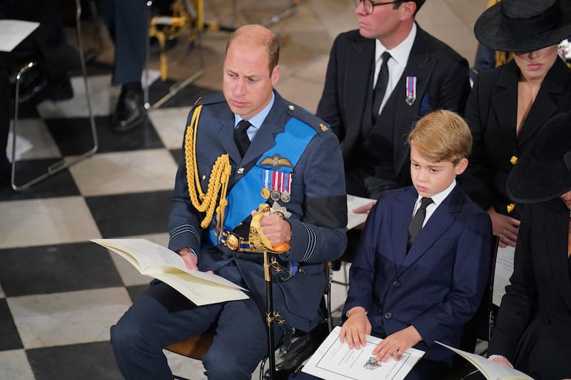 Prince William and Prince George, who have both seen their titles adjusted following Queen Elizabeth II's death, at the late monarch's funeral on Monday. AFP