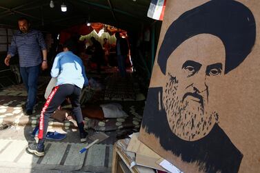 A poster of Iraq's Grand Ayatollah Ali Al Sistani stands outside a protest tent in Najaf on February 6, 2020, the day seven protesters were killed in the city. Reuters