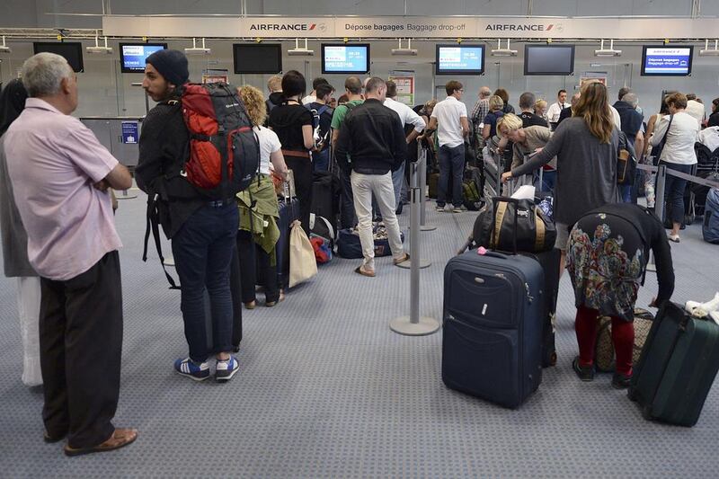 Passengers wait by the Air France desk at the Marseille-Marignane airport. southern France. The strike will cost the airline between €10 million to €15 million a day, its chief executive Frederic Gagey said. Boris Horvat / AFP