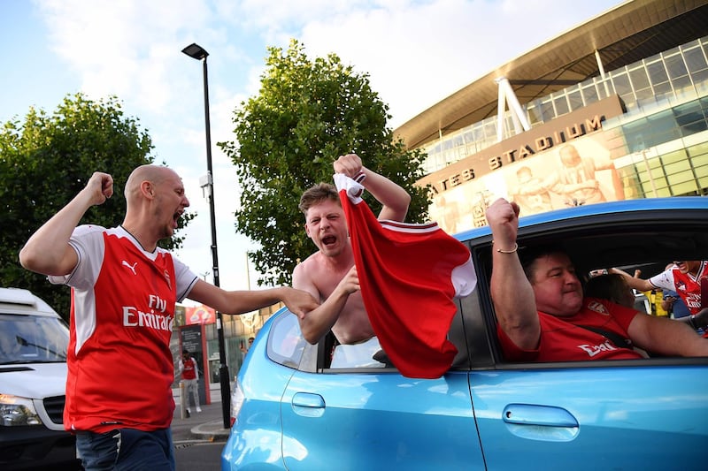 Arsenal fans celebrate outside the Emirates stadium. AFP