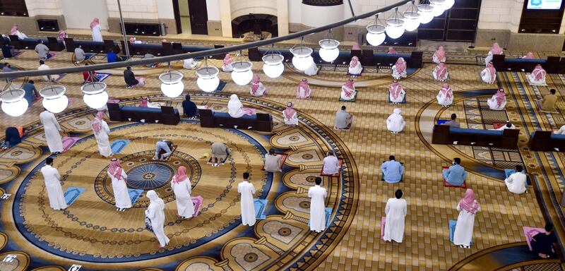 Saudi Muslims worshippers observe a safe distance as they perform noon prayer at Al-Rajhi mosque in the capital Riyadh. AFP