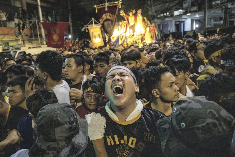 MANILA, PHILIPPINES - JANUARY 9: A Filipino Catholic devotee reacts as he expects to touch and see the Black Nazarene grimaces in pain as he is pushed back by soldiers guarding its route during its annual procession on January 9, 2020 in Manila, Philippines. The Feast of the Black Nazarene is attended by as many as 6 million barefoot devotees and happens every January 9th. The Black Nazarene is a dark wood sculpture of Jesus brought to the Philippines in 1606 from Spain and considered miraculous by Filipino devotees. (Photo by Ezra Acayan/Getty Images) *** BESTPIX ***