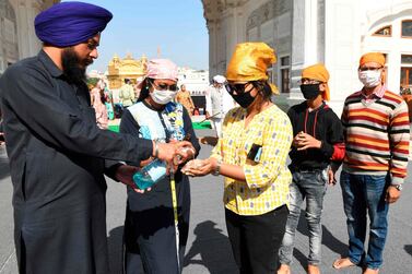 Devotees use hand sanitiser amid concerns over the spread of the Covid-19 coronavirus before entering the Golden Temple in Amritsar, India, on March 17, 2020. AFP