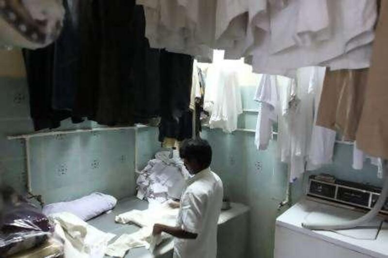 AL SHARJAH - AUGUST 2,2010 - Worker at laundry shop was force to close their shop during the  four day power cut that badly affect their business in Industrial Area 1, Sharjah. ( Paulo Vecina/The National )