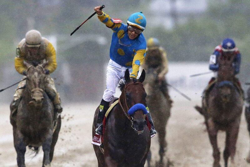 Victor Espinoza, centre, celebrates aboard American Pharoah after winning the 140th Preakness Stakes horse race at Pimlico Race Course on May 16, 2015. Patrick Semansky / AP Photo