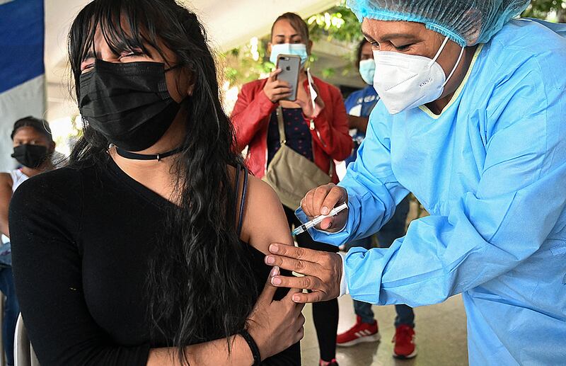 A young woman receives the first dose of the Pfizer-BioNTech COVID-19 vaccine in Tegucigalpa, Honduras, on September 13, 2021. Orlando Sierra / AFP