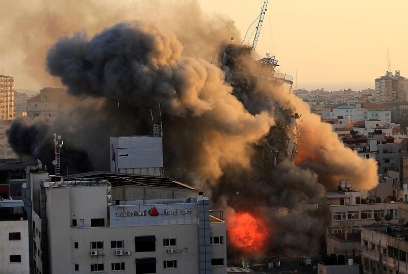 Heavy smoke and fire surround Al-Sharouk tower as it collapses during an Israeli air strike, in Gaza City on May 12, 2021. An Israeli air strike destroyed a multi-storey building in Gaza City today, AFP reporters said, as the Jewish state continued its heavy bombardment of the Palestinian enclave. AFP