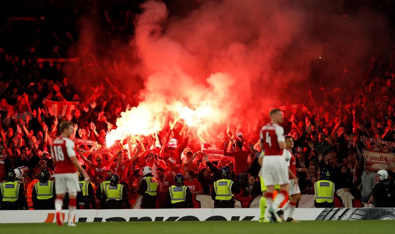 Cologne supporters fans celebrate their team's first goal by letting off flares. John Sibley / Reuters