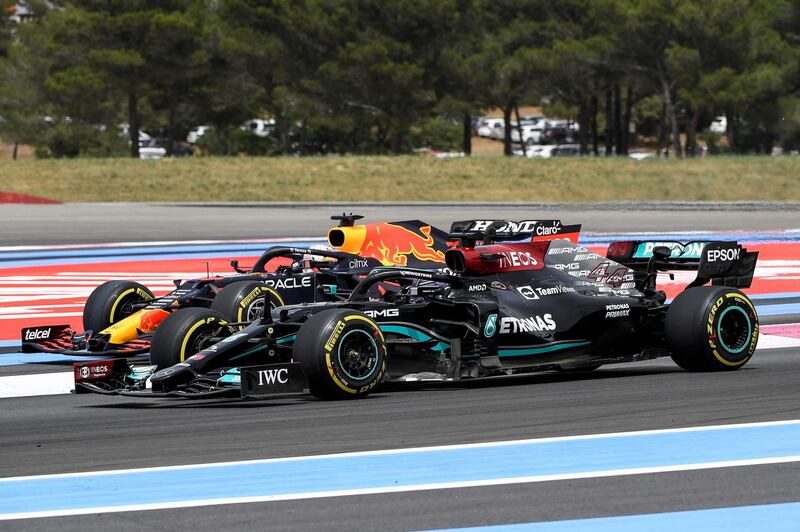 Lewis Hamilton overtakes Max Verstappen at the beginning of the race. AFP