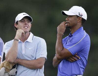Rory McIlroy, left, and Tiger Woods have spent time together on and off the course. Darron Cummings / AP Photo
