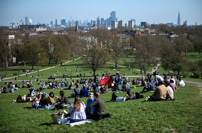 LONDON, ENGLAND - APRIL 04: People socialise in the sunshine on Primrose Hill on April 4, 2021 in London, England. Earlier this week, the UK government eased rules on socialising, permitting groups of six people (or more if limited to two households) to meet outdoors. The latest lockdown measures were imposed at the end of last year to curb a surge in Covid-19 cases. (Photo by Chris J Ratcliffe/Getty Images)