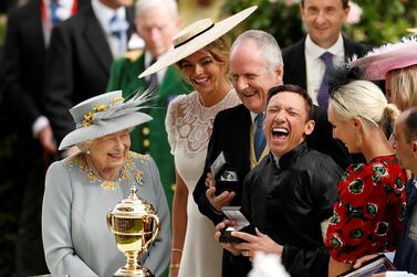 Horse Racing - Royal Ascot - Ascot Racecourse, Ascot, Britain - June 20, 2019 Frankie Dettori celebrates with the trophy after winning the 4.20 Gold Cup on Stradivarius as Britain's Queen Elizabeth looks on Action Images via Reuters/John Sibley TPX IMAGES OF THE DAY