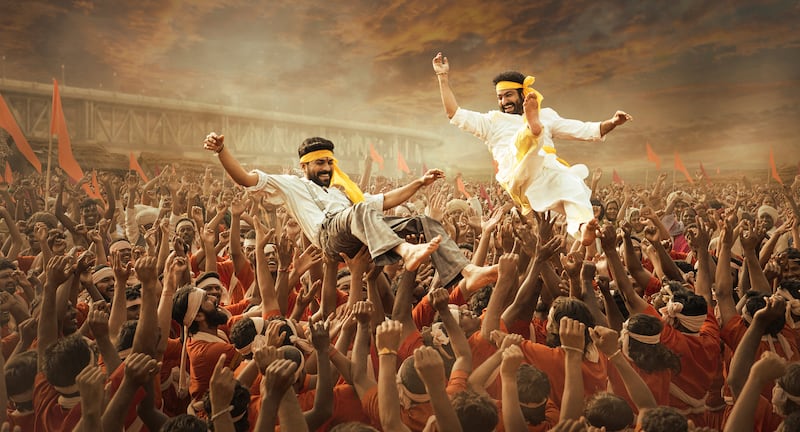 This image released by Netflix shows Ram Charan and N. T.  Rama Rao Jr.  in a scene from "RRR. " (Netflix via AP)