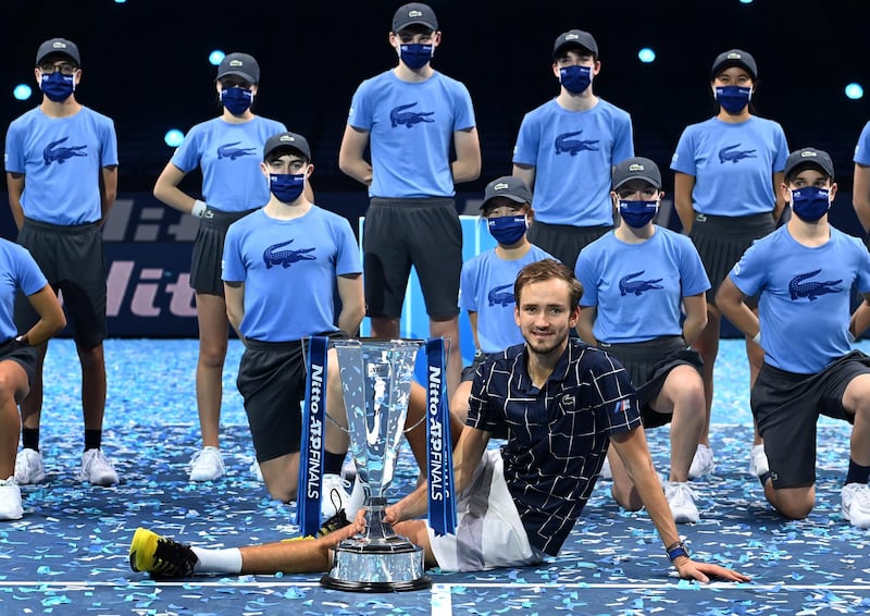 Daniil Medvedev poses with the ATP Finals trophy with ball boys and girls. EPA