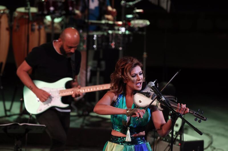 Tunisian singer and violinist Yasmine Azaiez (R) performs during the Hammamet International Festival in Hammamet, Tunisia. EPA