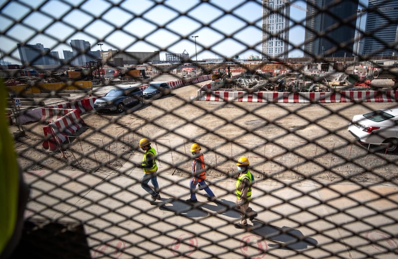 Workers at the Uptown Tower site, close to Dubai’s JLT district.