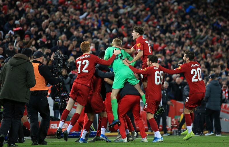 Liverpool players celebrate at the end of their League Cup win over Arsenal at Anfield. AP