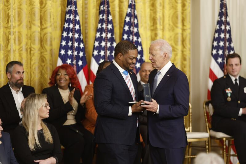 Eugene Goodman, a Capitol police officer, receives the Presidential Citizens Medal from Mr Biden. Bloomberg