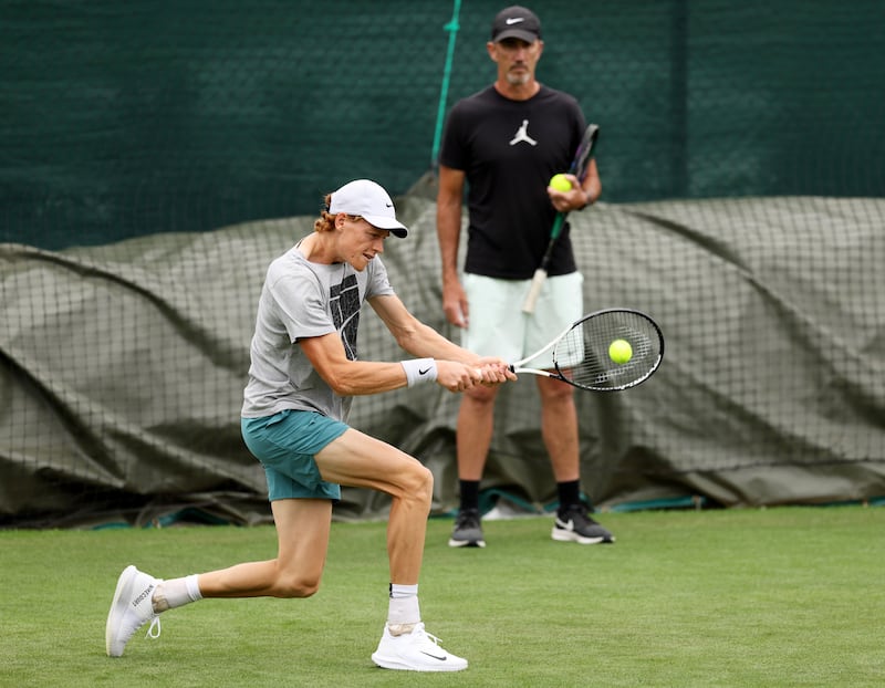 Jannik Sinner of Italy during training as coach Darren Cahill watches on. Getty