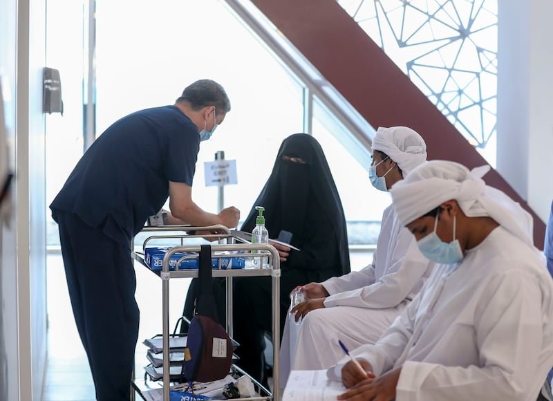 Nurses speak with patients at the Seha Vaccination Centre, Abu Dhabi Cruise Terminal, Zayed Port.
