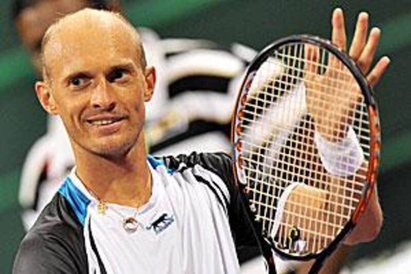 Nikolay Davydenko acknowledges the crowd after the win over Rafael Nadal in Doha.