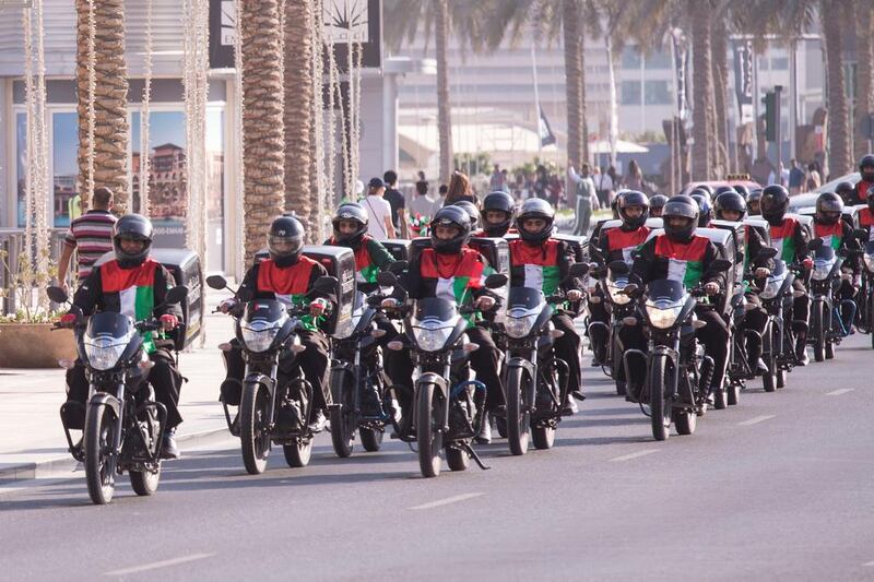 Thousands crowd Mohammed bin Rashid Boulevard as a procession passes by