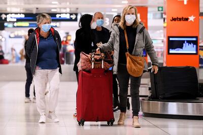 epa08524112 A passenger collects her baggage after arriving on a flight from Melbourne at Sydney Airport, Australia, 03 July 2020. Victoria state has recently seen soaring cases of coronavirus and incoming passengers from Melbourne will face screenings at Sydney Airport.  EPA/BIANCA DE MARCHI AUSTRALIA AND NEW ZEALAND OUT