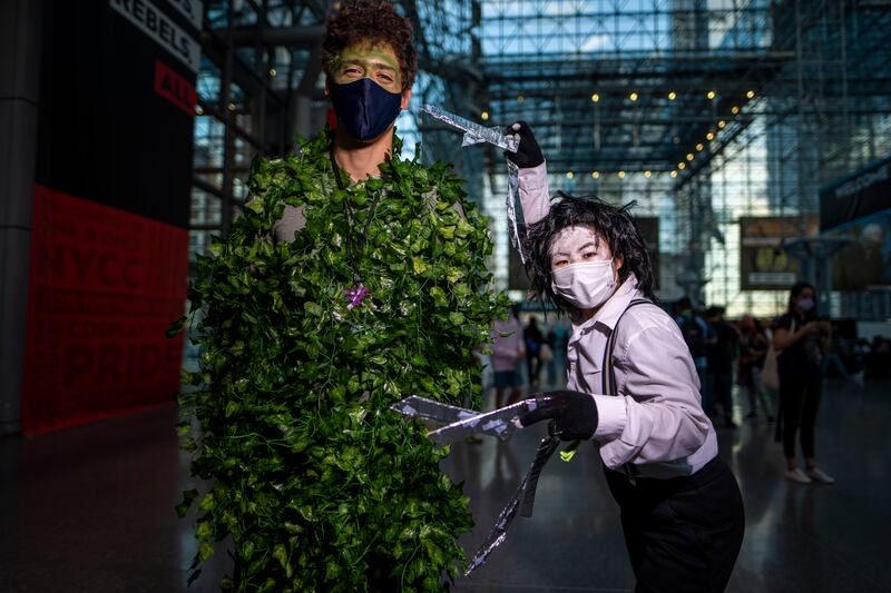 Attendees dressed as Edward Scissorhands and a bush pose during New York Comic Con. Charles Sykes / Invision / AP