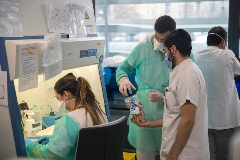 Medical staff perform an extraction of a Covid-19 sample at the Mediterranean institute of infection of La Timone hospital in Marseille, southern France, Thursday Feb. 27, 2020. (AP Photo/Daniel Cole)