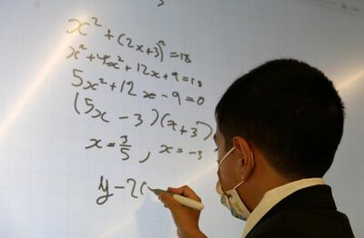 DUBAI, UNITED ARAB EMIRATES , March 9, 2021 –  Alex George solving the maths question at the Hartland International School in Dubai. Alex George, an 11-year-old pupil scored a 9 in IGCSE Mathematics. This is the highest score possible. Usually, children in year 11 (aged 15-16) sit for this exam, but Alex appeared for it four years in advance. Alex is in an accelerated programme at Hartland International School in Dubai. (Pawan Singh / The National) For News/Online. Story by Anam