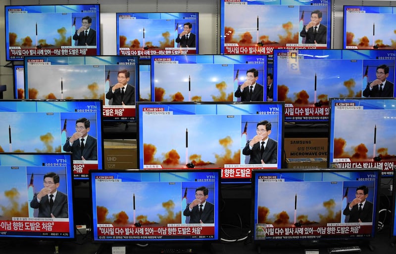 Television screens show a news report about the latest North Korean missile launch with file footage of a North Korean missile test, at an electronic market in Seoul. North Korea fired one long-range and two short-range ballistic missiles on November 3, Seoul's military said, with one prompting warnings for residents of a South Korean island and people in parts of northern Japan to seek shelter. AFP