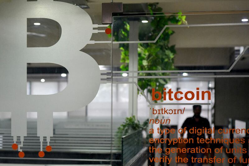 The symbol for Bitcoin is pictured at the entrance of a private office in Bangalore. India's government is working on legislation that could ban payments using digital currencies. AFP