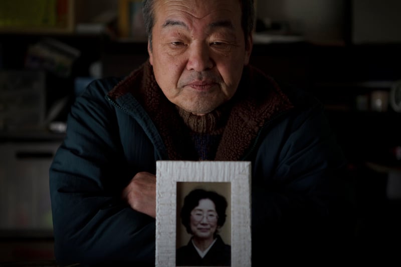 Yoshihiro Takahashi, 65, poses with a photo of his wife, Hisako, at his temporary house in Onagawa in Miyagi prefecture, Japan on Feb 15, 2012. Takahashi lost his wife, Hisako, and mother Satoko as well as his house by the massive tsunami hit the northern Japan on March 11, 2011.
Photo by Kuni Takahashi
