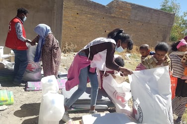 Workers from the International Committee of the Red Cross and volunteers from the Ethiopian Red Cross distribute relief supplies to civilians affected by the fighting in Tigray region. International Committee of the Red Cross via Reuters