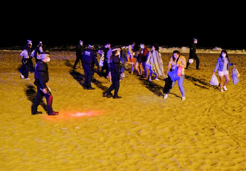 Police officers evict groups of more than six people at Barceloneta beach, as the state of emergency decreed by the Spanish Government to prevent the spread of the coronavirus was lifted a week ago in Barcelona, Spain. Reuters
