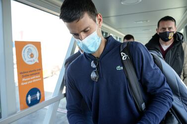 Novak Djokovic looks as his documents after landing in Belgrade, Serbia, Monday, Jan.  17, 2022.  Djokovic arrived in the Serbian capital following his deportation from Australia on Sunday after losing a bid to stay in the country to defend his Australian Open title despite not being vaccinated against COVID-19. (AP Photo / Darko Bandic)