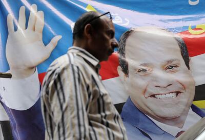 A man walks by a poster of Egyptian President Abdel Fattah al-Sisi for the upcoming presidential election, in Cairo, Egypt March 19, 2018. REUTERS/Mohamed Abd El Ghany