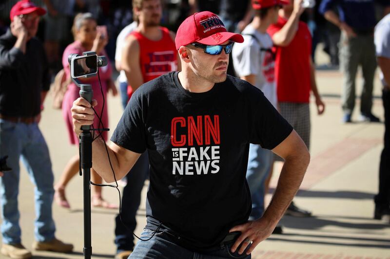 A Trump supporter wears a "CNN is fake news" t-shirt at a “Turn California Red” rally that drew a small crowd of anti-fascist counter-protesters in Sacramento, California, U.S. November 4, 2018. REUTERS/Elijah Nouvelage