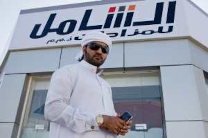 Ali Bin Saif, owner of Al Shamil auctions, poses for a portrait in front of his nearly finished shop on Jumeirah Beach Road, in Dubai, UAE, on September 16, 2009. Among other items, Mr. Saif, auctions Blackberry Instant Messaging Numbers, which are being auctioned for large sums of money. *** Local Caption ***  marin_blackberry_03.jpg