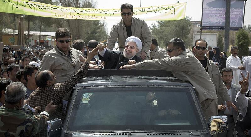 Iranian President Hassan Rouhani greets supporters after his arrival in Zahedan, the regional capital of Sistan and Baluchestan province on Tuesday, April 15, 2014. During Mr Rouhani's two-day visit, he will tour several other cities and hold meetings with local scholars and entrepreneurs. Maryam Rahmanian for The National