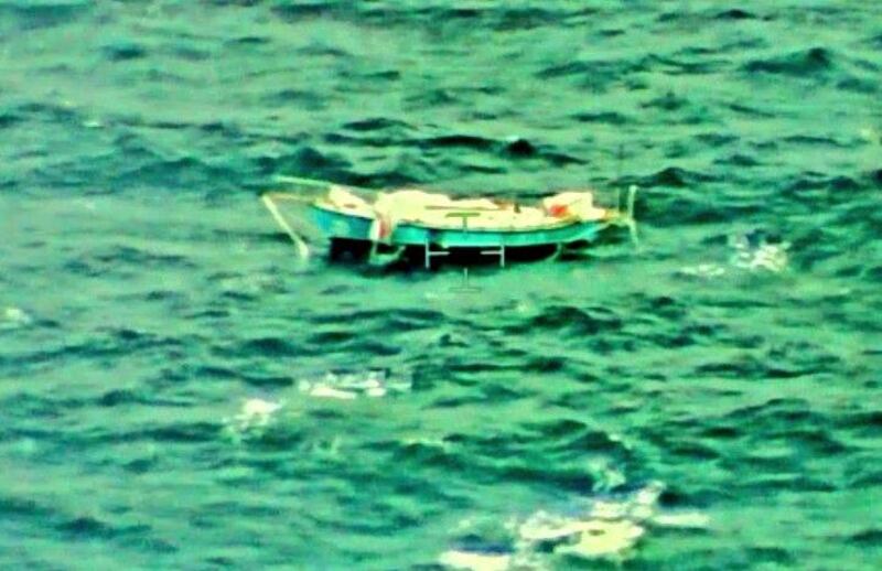 The capsized yacht Thuriya of solo sailor Abhilash Tomy is pictured at sea in this September 24, 2018 handout photo by the Indian Navy. Indian Navy/Handout via REUTERS    ATTENTION EDITORS - THIS PICTURE WAS PROVIDED BY A THIRD PARTY. NO RESALES. NO ARCHIVE.