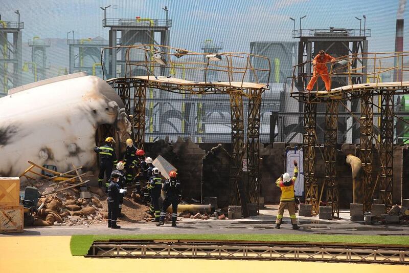 Firefighting teams take part in a simulation exercise involving a mock airplane crash at ADNEC. Courtesy Security Media