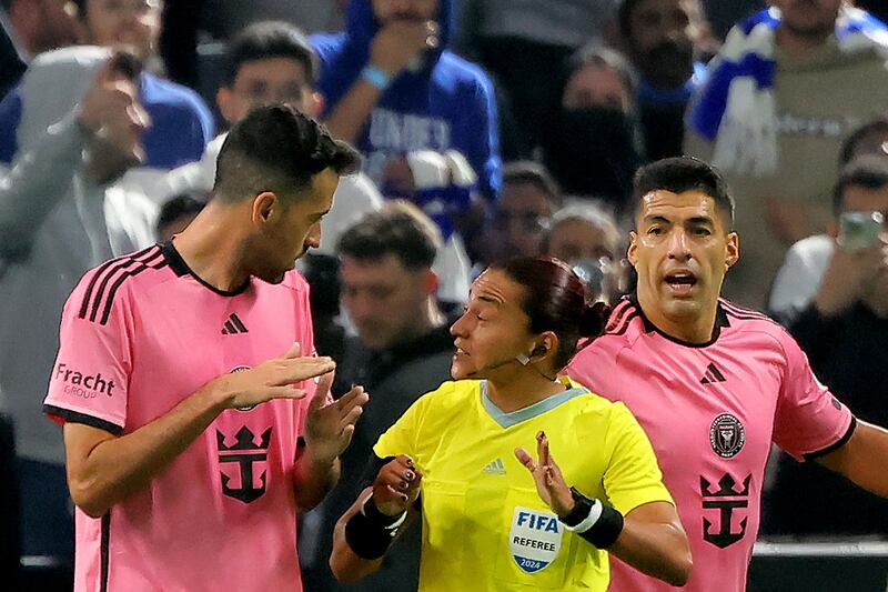 Inter Miami's Spanish midfielder Sergio Busquets speaks with Brazilian match referee Edina Alves Batista during the friendly exhibition match against Al Hilal. AFP