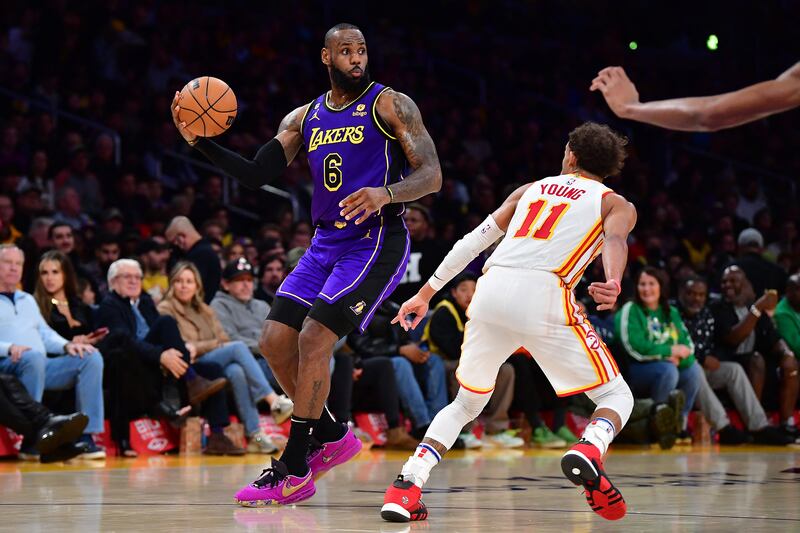 Los Angeles Lakers forward LeBron James controls the ball against Atlanta Hawks guard Trae Young. USA TODAY Sports