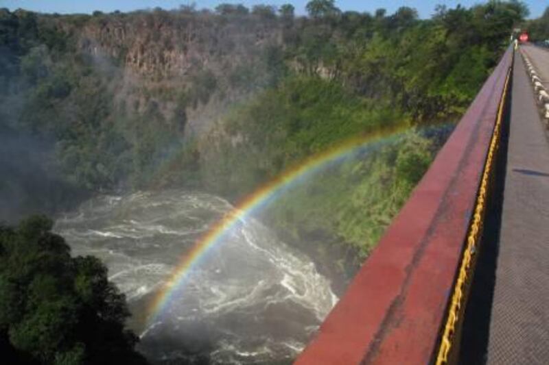 View from the Victoria Falls Bridge crossing the Zambezi River just below Victoria Falls. When the water is high, the mist from the falls creates a permanent rainbow under the bridge. The highest railway bridge in the world when it opened in 1905, Victoria Falls Bridge links the Zambian city of Livingstone and the Zimbabwean city of Victoria Falls, and is now used for bunjee jumping. Photo by Scott MacMillan
