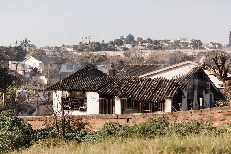 A picture taken on July 16, 2021 shows a house destroyed after angry mobs set fire to homes in Duffs Road near Phoenix, where racial tensions have also been reported as President Cyril Ramaphosa visits the Kwazulu-Natal province where violence continued for 6 days.  - South African President Cyril Ramaphosa on Friday alleged that deadly violence and looting that have shaken the country over the past week were planned. 
"It is quite clear that all these incidents of unrest and looting were instigated -- there were people who planned it and coordinated it," Ramaphosa said in a visit to KwaZulu-Natal (KZN) province, the flarepoint for post-apartheid South Africa's worst crisis.