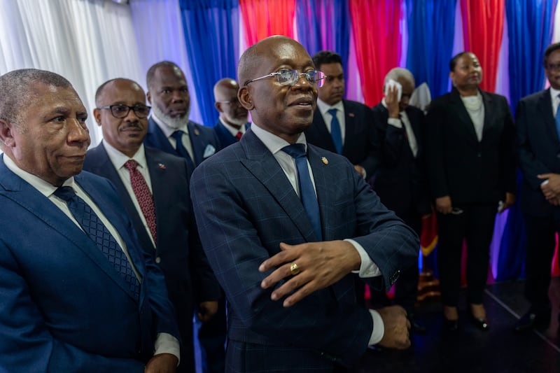 Interim Prime Minister Michel Patrick Boisvert, centre, is flanked by transitional council members during an installation ceremony, in Port-au-Prince, Haiti. AP